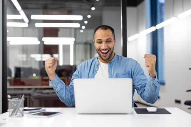 istock Success celebration in a modern office with a fist pump 2105415561