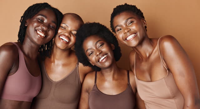 Laughing, face or African models with beauty, glowing skin or results isolated on brown background. Facial dermatology, friends hug or natural skincare in studio with black women or happy people