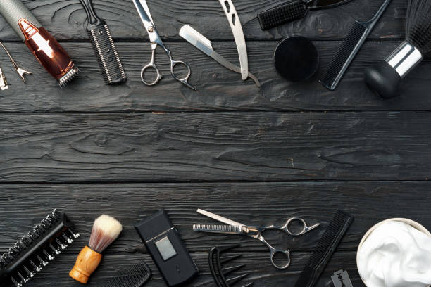 Professional Barber Tools Laid Out on Dark Wooden Surface