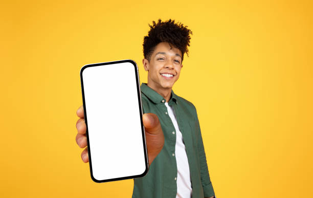 istock Cool young black guy showing phone with white screen 2105491457