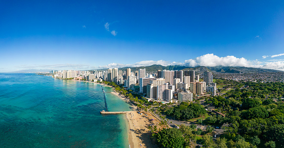 Aerial view of the skyline of Honolulu with Waikiki Beach, the skyscrapers and the mountains in the background. Panorama with extremely high resolution - Oahu, Hawaii