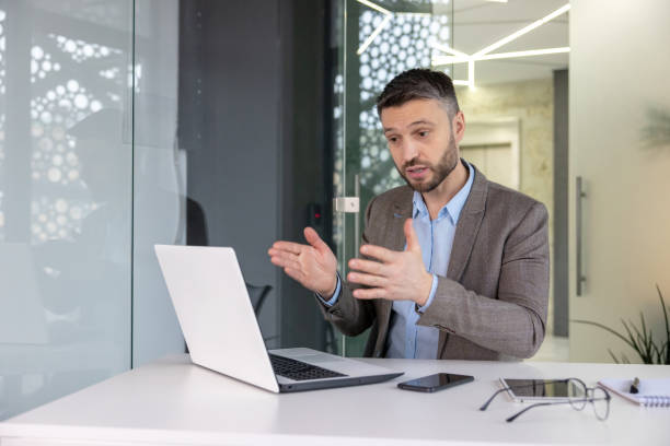 istock Professional businessman giving a presentation in modern office setting 2105686868