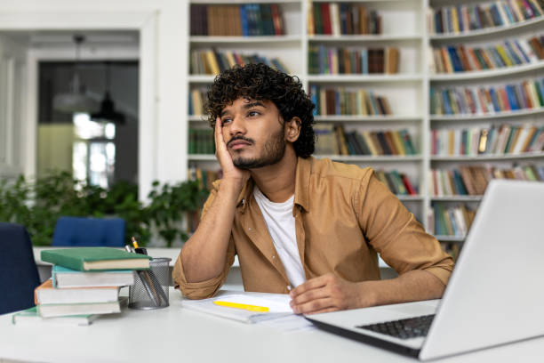 istock University student studying in library for exam preparations 2105701799