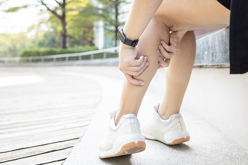 Exercise Associated Muscle Cramps,woman suffering from calf pain,muscular spasms and cramps or Achilles tendinitis,damage to muscles and tendons in calf of the leg,pain in Gastrocnemius and Soleus