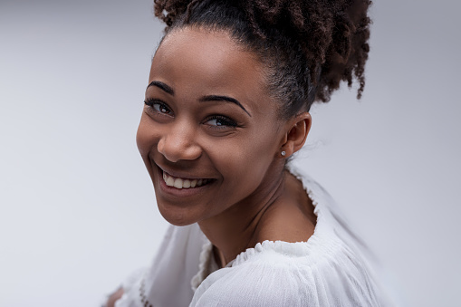 woman's cheerful visage and sparkling eyes communicate an infectious zest for life and contentment