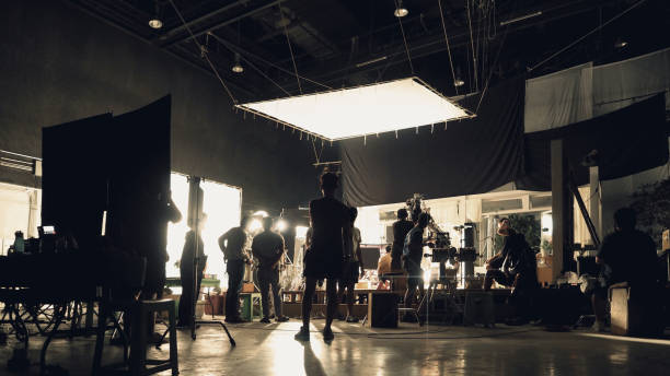 istock Silhouette of people working in big production studio 2105831975