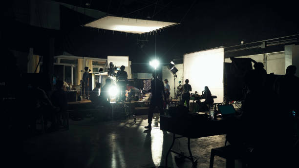istock Silhouette of people working in big production studio 2105831976