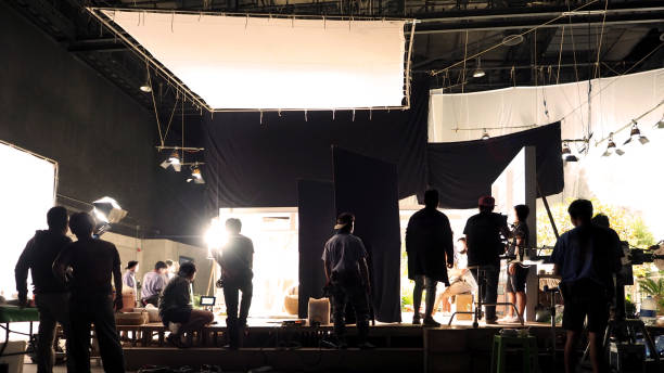 istock Silhouette of people working in big production studio 2105831977