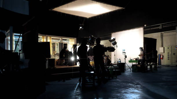 istock Silhouette of people working in big production studio 2105831980