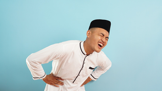 muslim man backache blue background