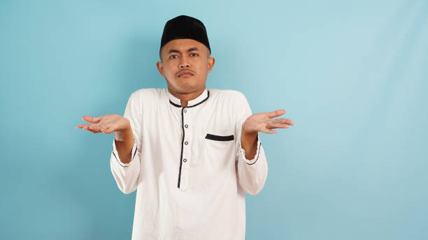 istock Muslim man not knowing , confused, clueless gesture on blue background 2105855772