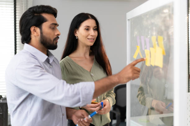 istock Diverse group of people talking, brainstorming marketing strategy together. 2105898893