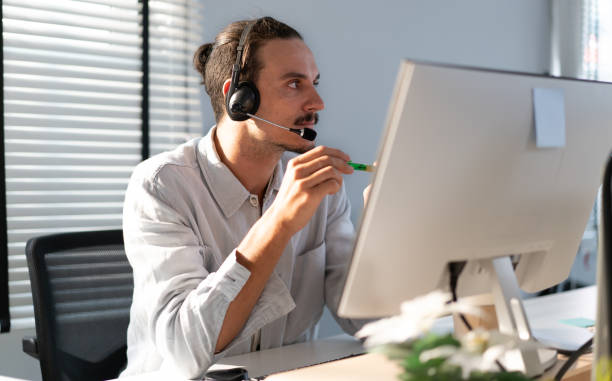 istock Customer service operator wear headset working at call center office help people in telemarketing helpline. 2105899396