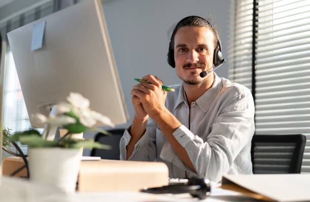 istock Customer service operator wear headset working at call center office help people in telemarketing helpline. 2105899398