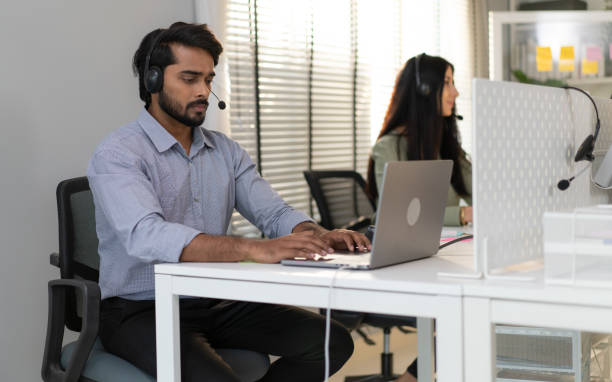 istock Customer service operator wear headset working at call center office help people in telemarketing helpline. 2105899921