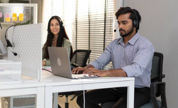 istock Customer service operator wear headset working at call center office help people in telemarketing helpline. 2105899923