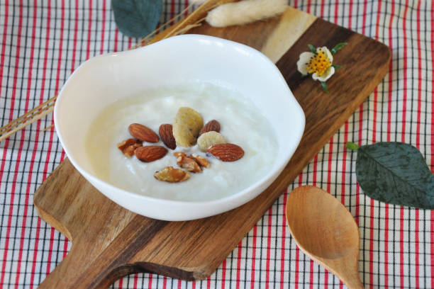 istock Heathy Meal Plain Yogurt with Nuts in White Bowl 2105934305