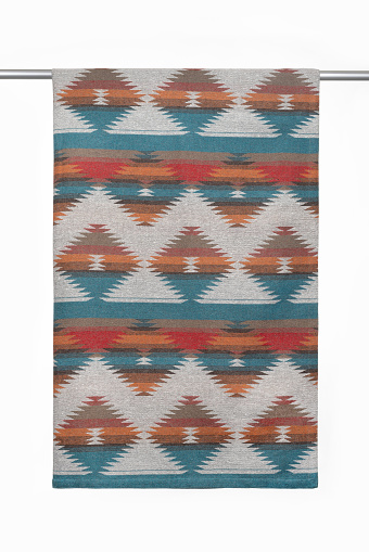 Textile background from a woolen scarf, tippet, with a geometric pattern, close-up, studio shot.