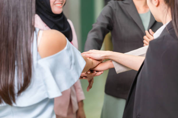 istock Success Teamwork Concepts, Business people with joined hands as a team, Group of diverse hands together joining, Young businesswomen team putting their hands together 2105977536