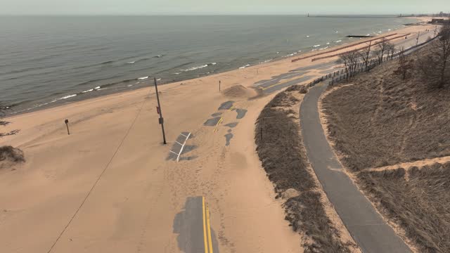 A sandy storm across the springtime beach.
