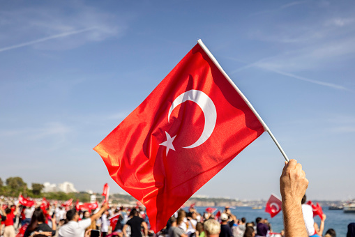 Turkish flags raised in the hands