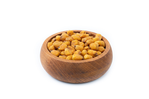 Roasted Corn Snack in wooden bowl isolated on white background.