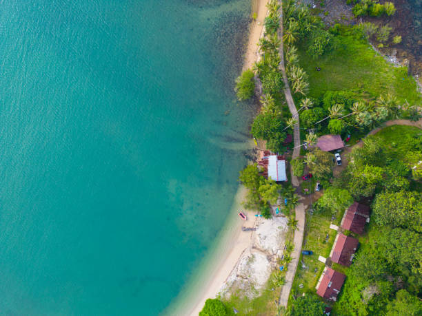 istock Aerial view sea beach wave white sand beach with green tree forest 2106056998