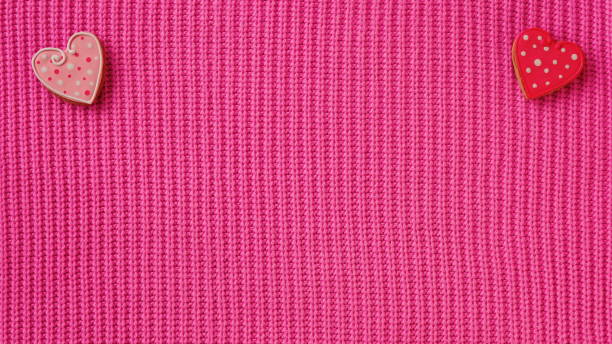 istock Heart-Shaped Buttons On Pink Knit Fabric. A Top View Showing Two Decorative Elements On A Textured Background 2106057551