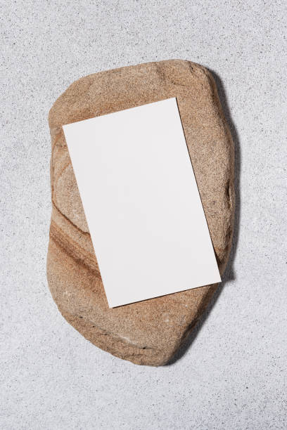 istock Blank paper sheet card on natural stone background 2106080196