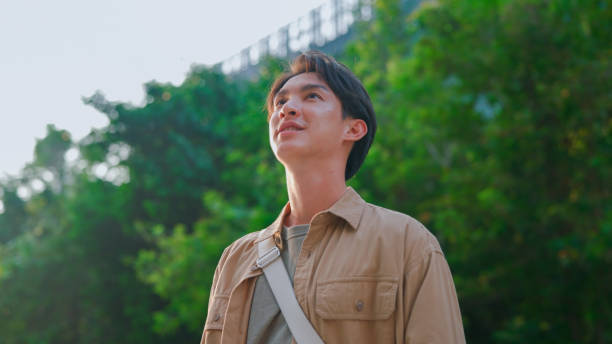 istock Asian man walking in public park 2106080231