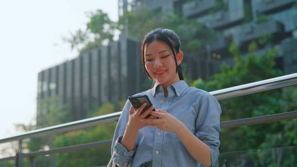 istock Asian woman using smart phone 2106080784