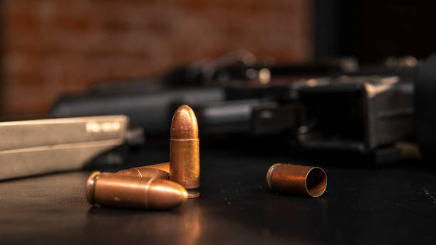 istock Several shell casings on the background of a machine gun 2106094919