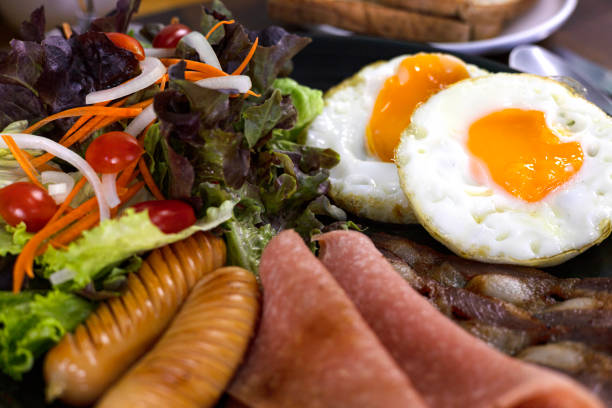 istock Healthy Breakfast With Fresh Organic Vegetable Salad Fried Egg And Sausages 2106099223