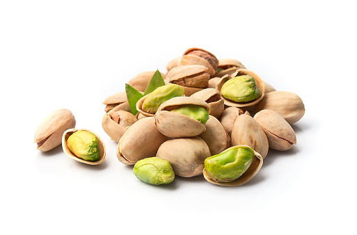 Pile of pistachios in white backgrounds. Healthy food