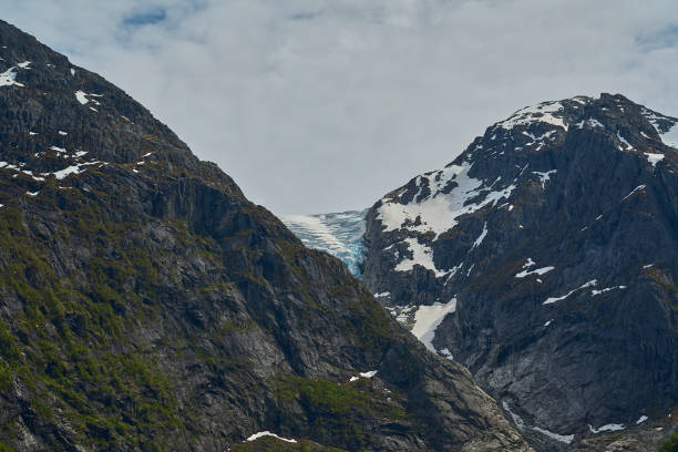 istock Bondhusbreen Glacier hanging over the Bondhusvatnet Lake. 2106143699