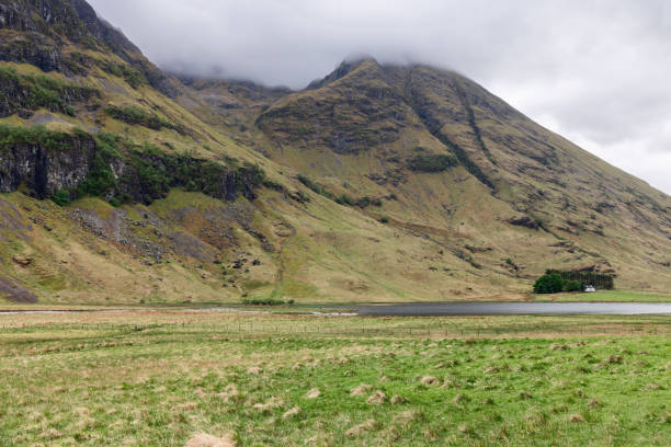 Enveloped by the Three Sisters, this verdant valley near the viewpoint captivates with its rugged cliffs and a misty embrace, offering a classic Highland spectacle