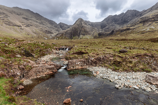 The Fairy Pools of Isle of Skye reveal their tranquil beauty with crystal-clear waters flowing against a backdrop of majestic Cuillin ridges