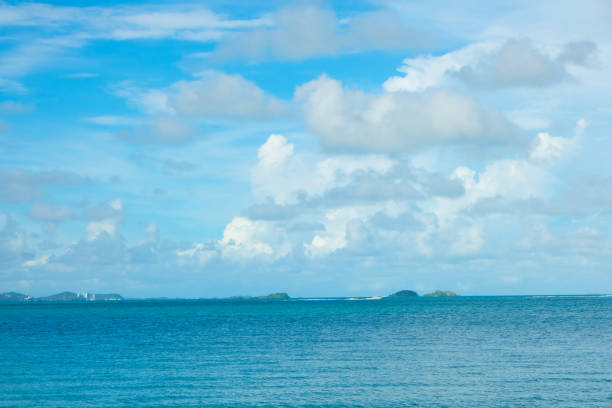 Tropical sea beach wave against blue sky with fluffy cloud nature landscape