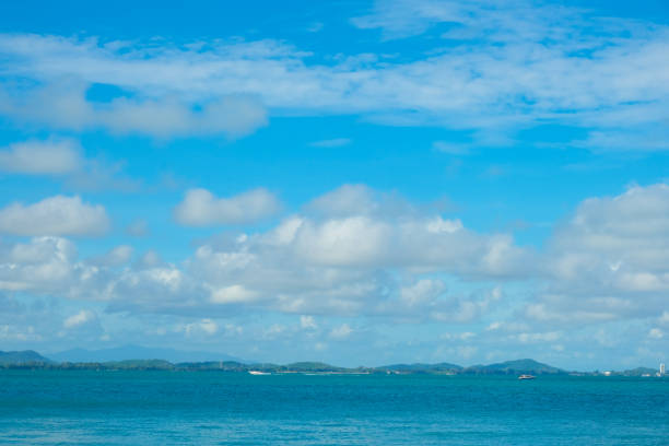 Tropical sea beach wave against blue sky with fluffy cloud nature landscape