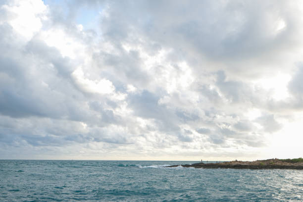 Tropical sea beach wave against blue sky with fluffy cloud nature landscape