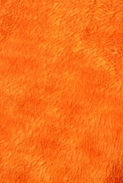 istock Orange Colored Fur Fabric Background with Copy Space in Vertical Orientation 2106158384