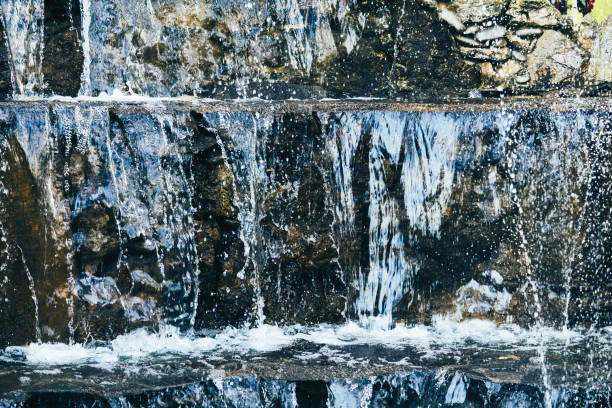 istock Pure mineral blue water flows over stepped mountain stones 2106165207