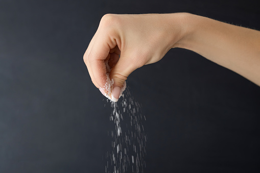 hand sprinkling edible salt