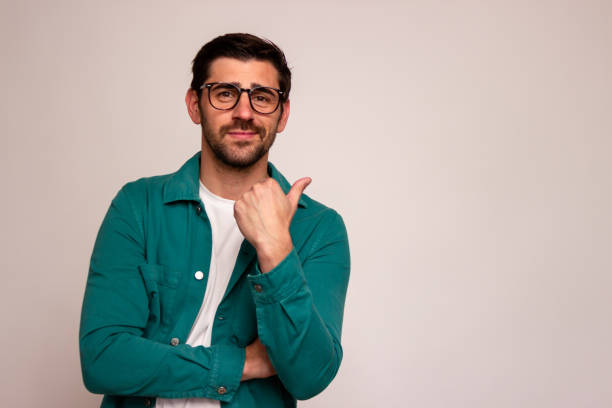 istock Confident man pointing sideways in casual attire 2106264979
