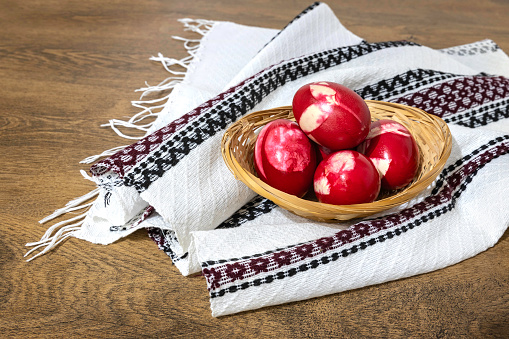 Romanian red Easter eggs on a wooden table. Top view of this traditional food in Romanian families during holidays.