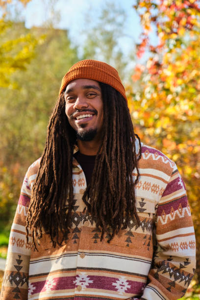 istock African young man with dreadlocks smiling and looking at camera in fall. 2106292932