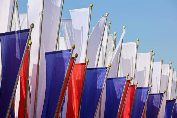 istock Russian flags waving on background of blue sky 2106301710