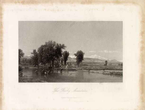 istock VIEW of The ROCKY MOUNTAINS w/ Natives, Teepee, Horses, River 2106332985