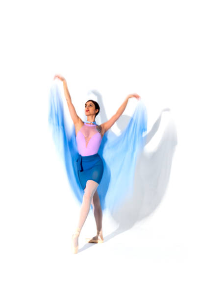 istock Young ballerina in blue skirt dances in studio light.Long exposure. White Background 2106346047
