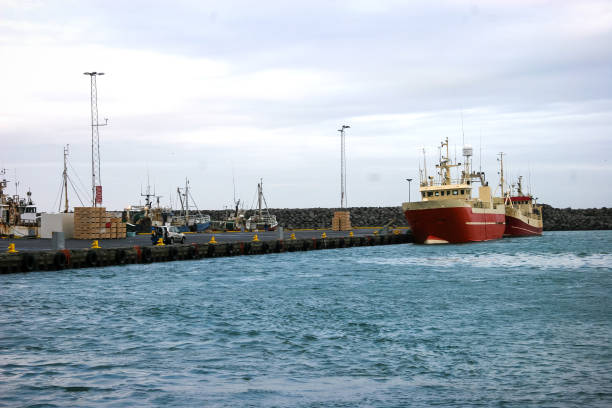 A single ship sitting at a dock with commercial equipment